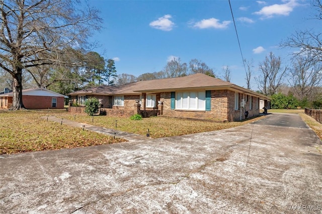 ranch-style house featuring a front lawn and brick siding