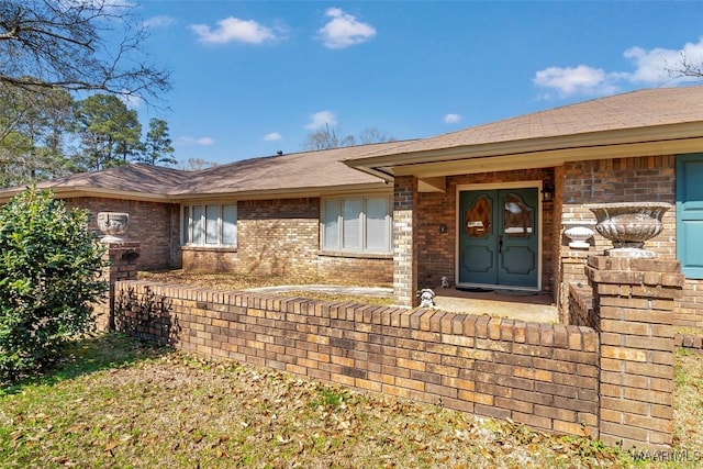 property entrance featuring brick siding