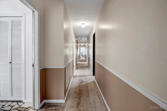 hall featuring a wainscoted wall