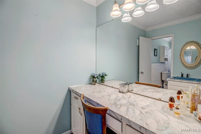 bathroom with ornamental molding and vanity