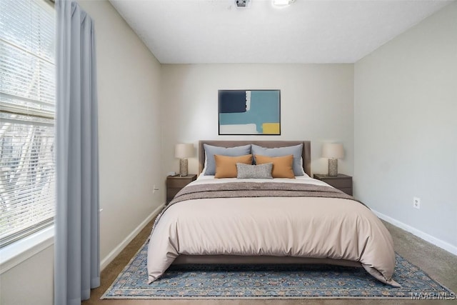 bedroom with carpet floors and baseboards