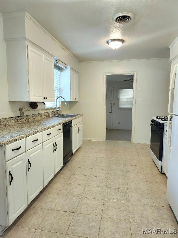 kitchen featuring a sink, white cabinetry, visible vents, black dishwasher, and range with gas stovetop