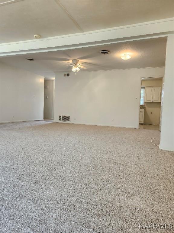 empty room featuring ceiling fan and visible vents