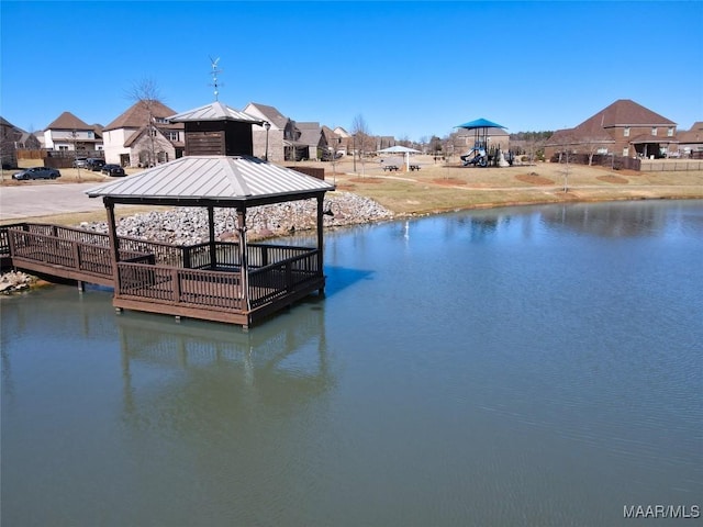 view of dock featuring a gazebo and a water view