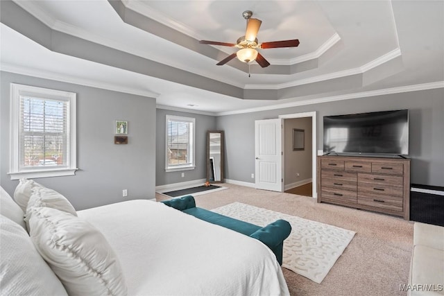 bedroom with ceiling fan, light colored carpet, baseboards, a raised ceiling, and crown molding