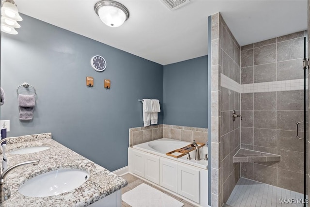 bathroom with a garden tub, a stall shower, a sink, and visible vents