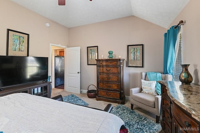 bedroom featuring a ceiling fan, light carpet, vaulted ceiling, and baseboards