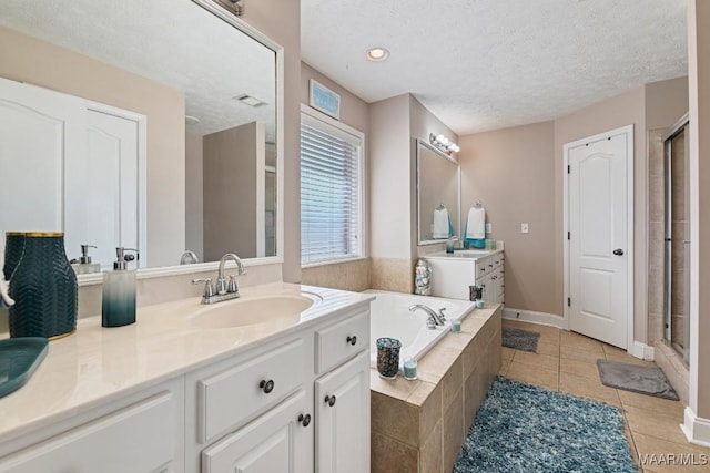 full bath featuring a stall shower, tile patterned flooring, a textured ceiling, and a bath