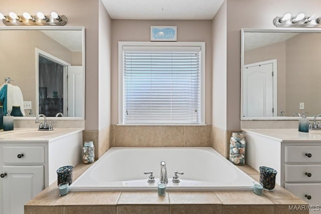 bathroom featuring vanity and a bath