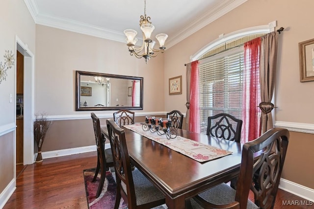 dining space featuring crown molding, a notable chandelier, baseboards, and wood finished floors