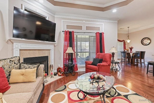 living room with a fireplace, ornamental molding, wood finished floors, and recessed lighting