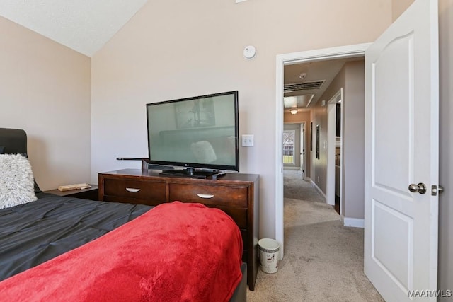 carpeted bedroom with lofted ceiling and baseboards