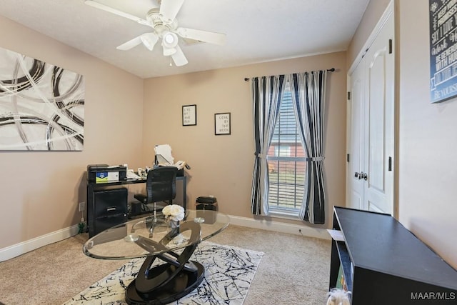 office space with carpet, ceiling fan, and baseboards