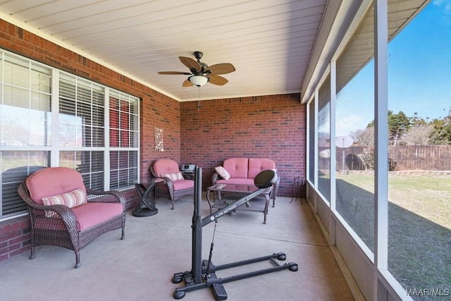 sunroom / solarium with a ceiling fan