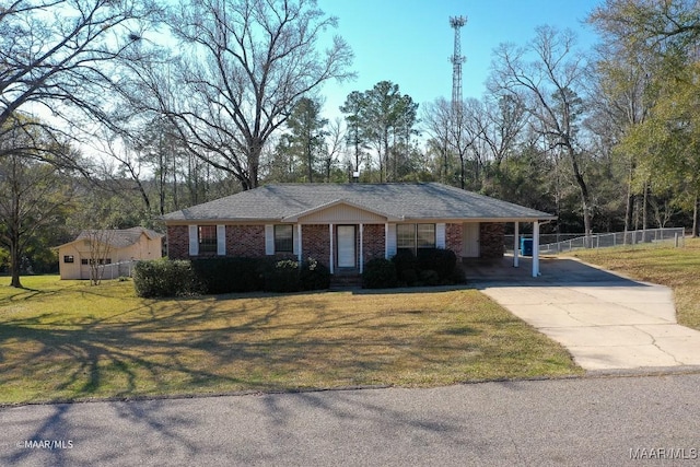 view of front of house featuring brick siding, fence, driveway, a carport, and a front yard