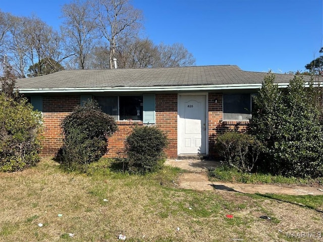 view of front of property with brick siding and a front yard
