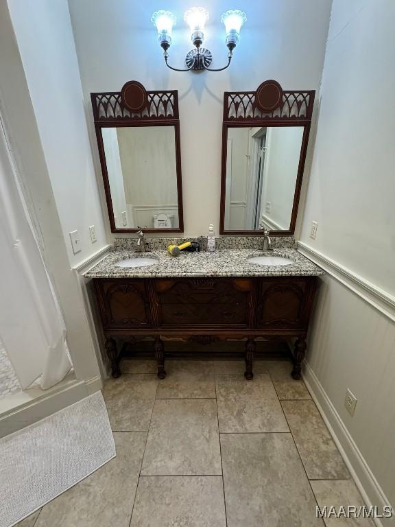 full bath featuring tile patterned floors, a sink, and double vanity