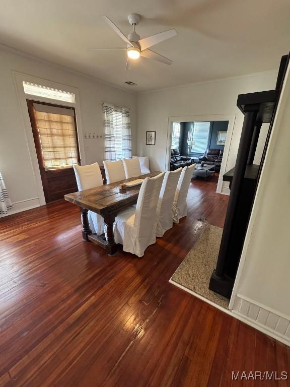 dining room with wood-type flooring, baseboards, and a ceiling fan