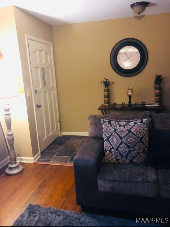 entryway with dark wood-style flooring and baseboards