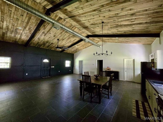 unfurnished dining area featuring ceiling fan with notable chandelier, high vaulted ceiling, wooden ceiling, and beam ceiling