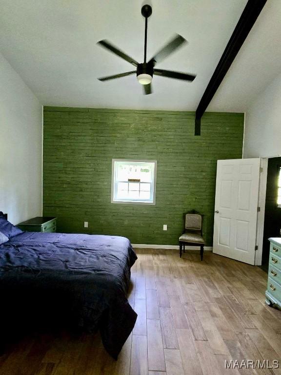 bedroom featuring light wood-style floors, ceiling fan, baseboards, and beam ceiling