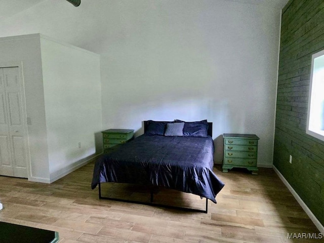 bedroom with wood finished floors and baseboards