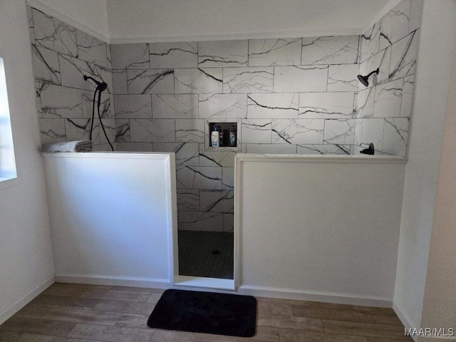 interior space featuring wood finished floors, walk in shower, and tile walls