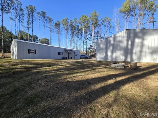 exterior space featuring an outbuilding, a yard, and an outdoor structure