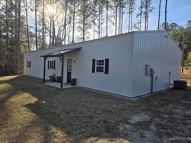 back of house featuring cooling unit and a yard