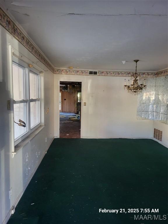 interior space with baseboards, visible vents, and an inviting chandelier