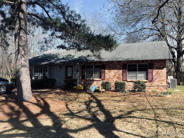 ranch-style home featuring brick siding and cooling unit