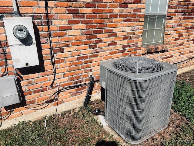 exterior details with brick siding and central AC unit