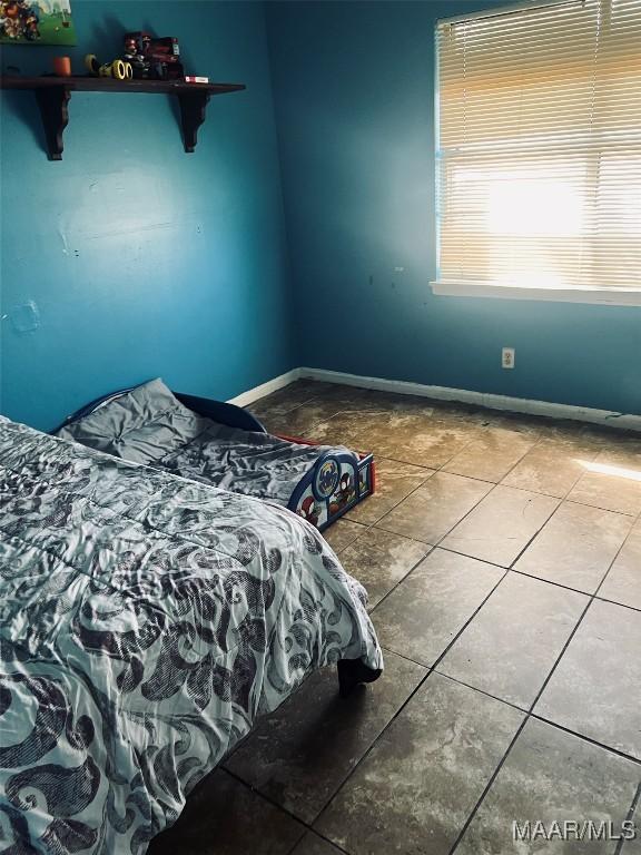 tiled bedroom with baseboards