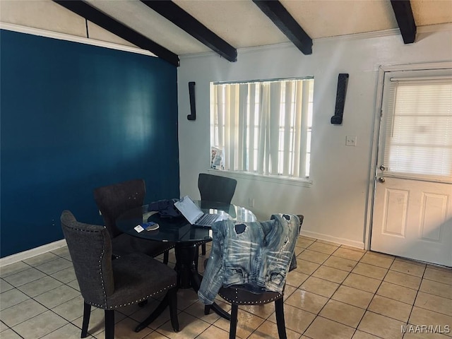 dining space with vaulted ceiling with beams, light tile patterned flooring, and baseboards