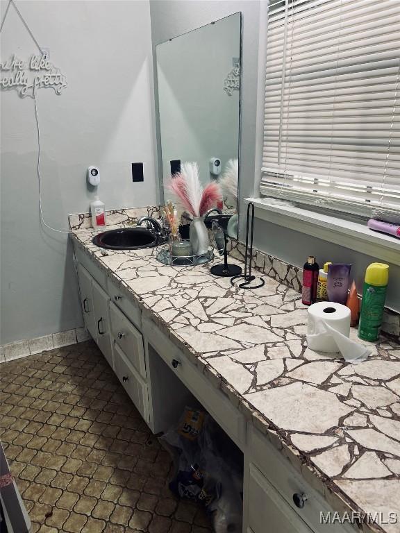 bathroom with vanity and baseboards