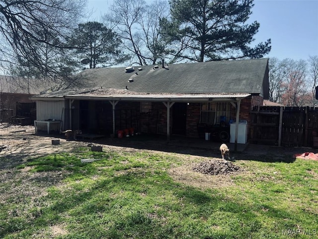 back of property with central AC, a lawn, and fence