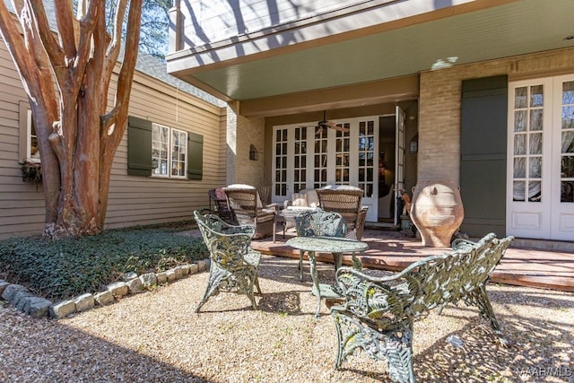 view of patio / terrace featuring ceiling fan and french doors