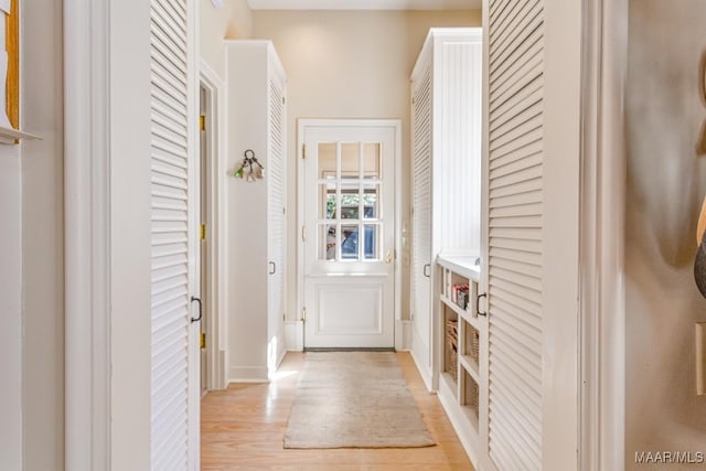 entryway featuring light wood-style flooring and baseboards