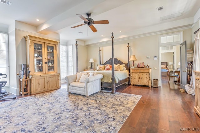 bedroom with visible vents, dark wood finished floors, and baseboards