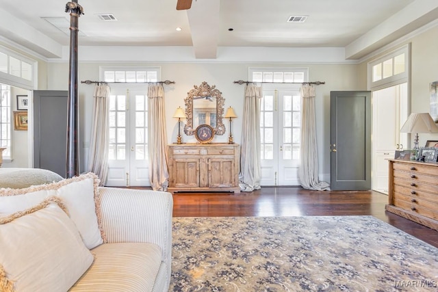 bedroom with visible vents, beamed ceiling, dark wood-style flooring, and french doors