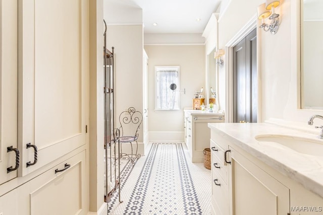 full bathroom featuring shower / tub combination, two vanities, a sink, baseboards, and crown molding