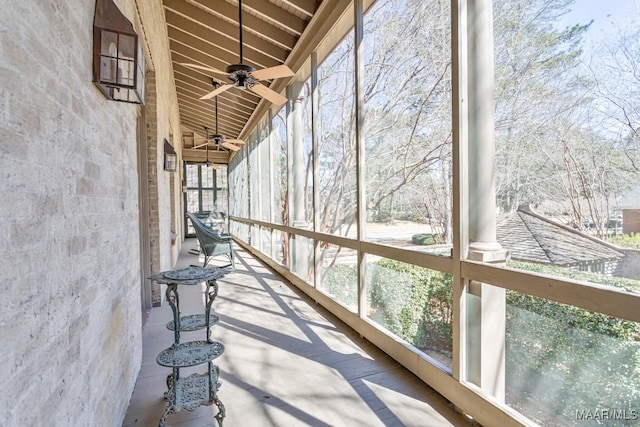 unfurnished sunroom with a ceiling fan