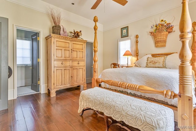 bedroom featuring ornamental molding, dark wood finished floors, baseboards, and a ceiling fan