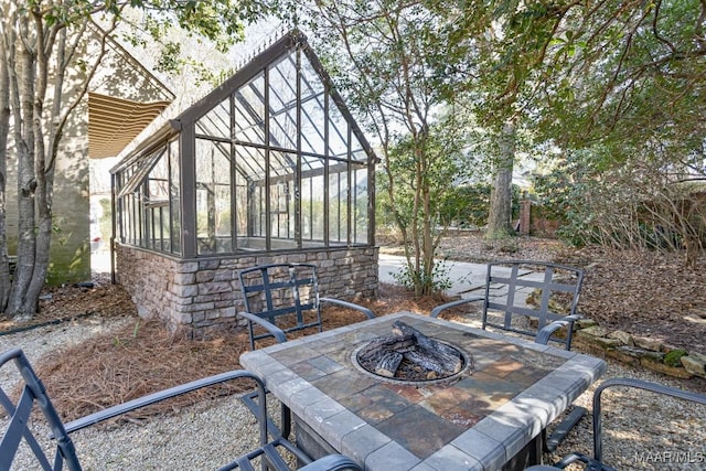 view of patio featuring an outdoor fire pit and an outdoor structure