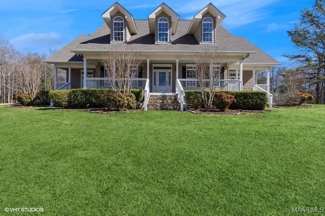 new england style home featuring covered porch and a front lawn