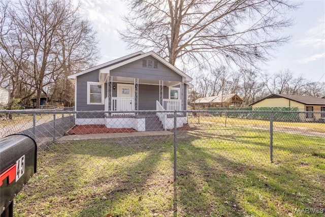 bungalow-style home featuring a fenced front yard, a porch, and a front lawn