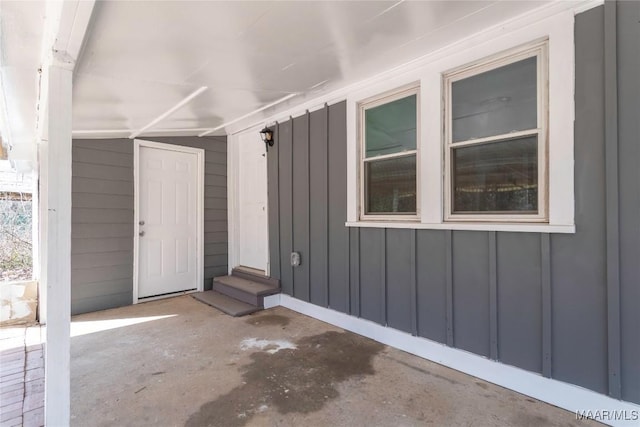 view of exterior entry with board and batten siding