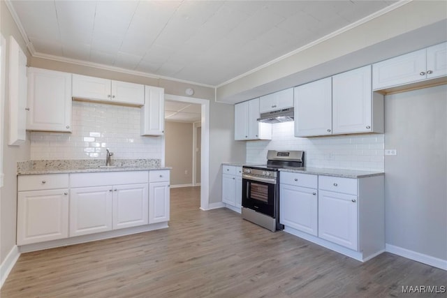 kitchen with stainless steel electric stove, light wood-style flooring, white cabinets, a sink, and under cabinet range hood