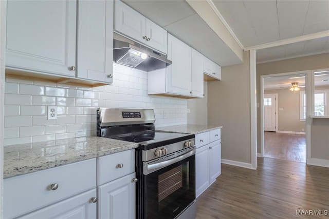 kitchen with dark wood finished floors, ornamental molding, stainless steel electric range, under cabinet range hood, and white cabinetry