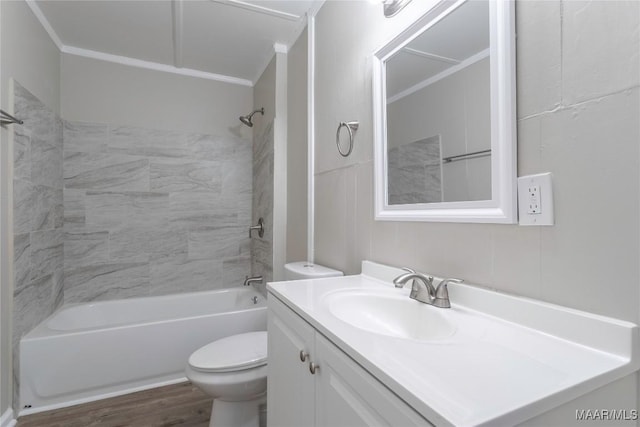 bathroom featuring bathtub / shower combination, vanity, toilet, and wood finished floors